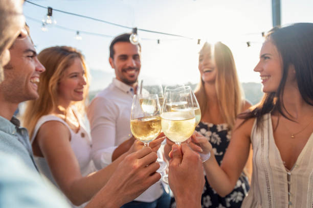 Friends sharing drinks at sunset